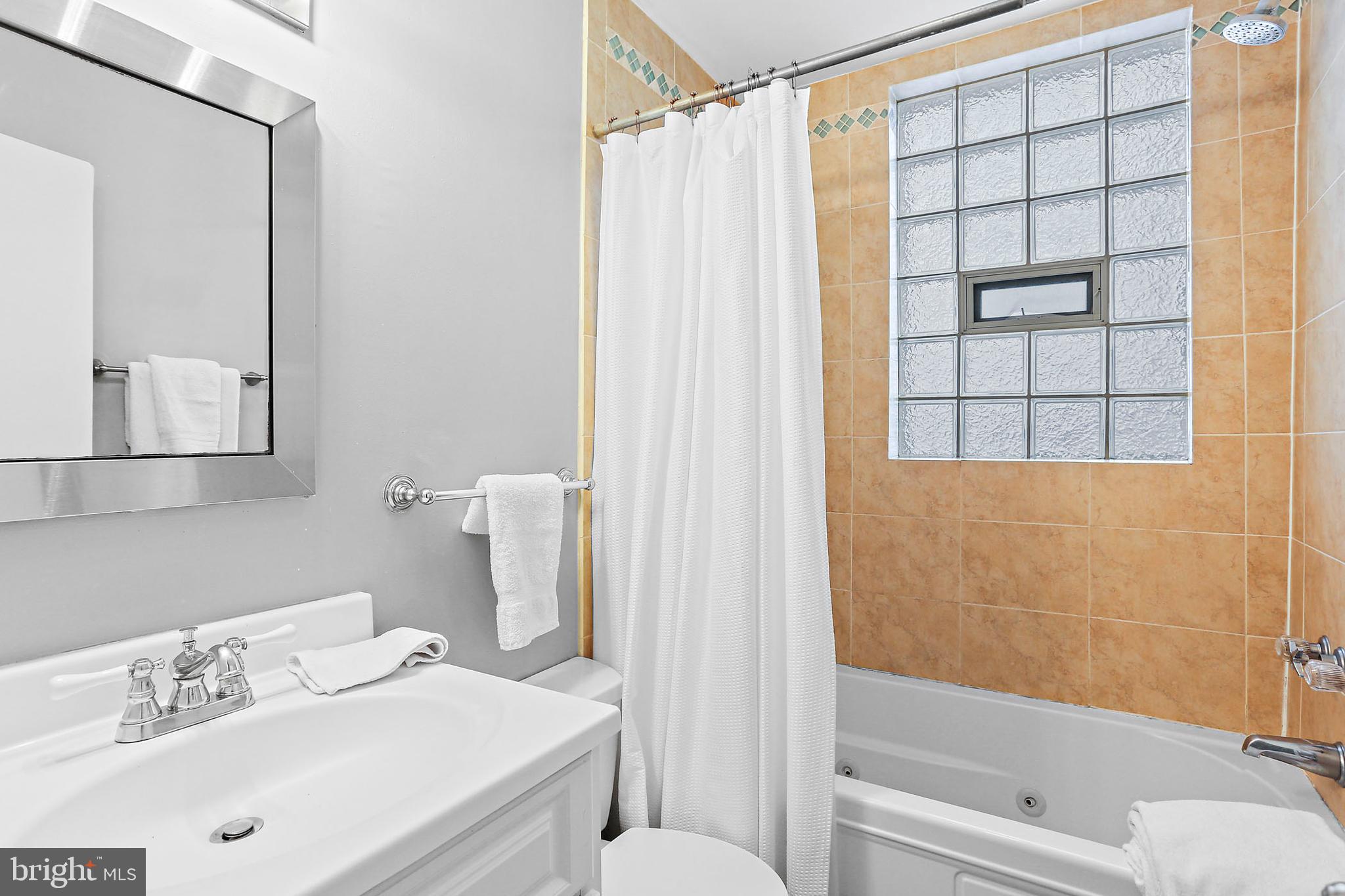 1211 33rd Street Northwest, Unit 1 Washington, DC 20007 - Photo 12 of 18 a bathroom with a sink toilet and shower