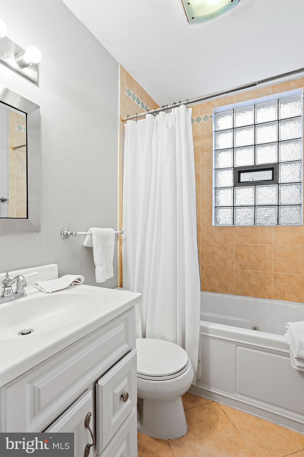1211 33rd Street Northwest, Unit 1 Washington, DC 20007 - Photo 13 of 18 a bathroom with a sink a toilet and a bathtub