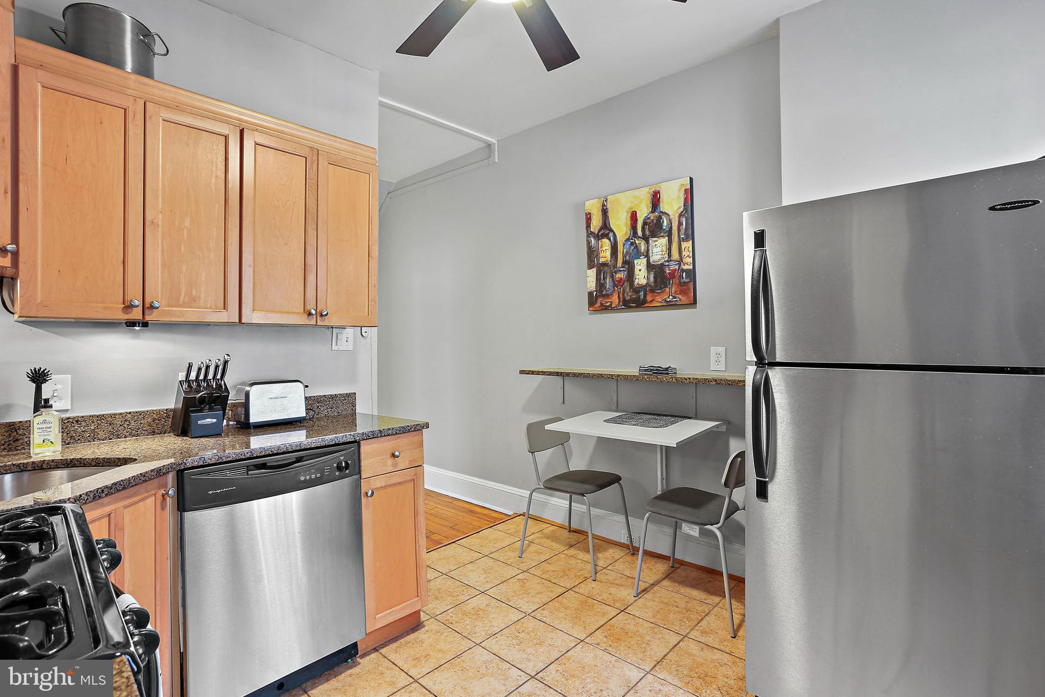 1211 33rd Street Northwest, Unit 1 Washington, DC 20007 - Photo 16 of 18 a kitchen with stainless steel appliances granite countertop a refrigerator and a stove top oven