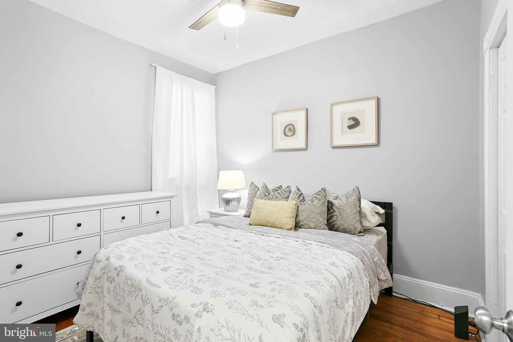 1211 33rd Street Northwest, Unit 1 Washington, DC 20007 - Photo 8 of 18 a bedroom with a bed and a window