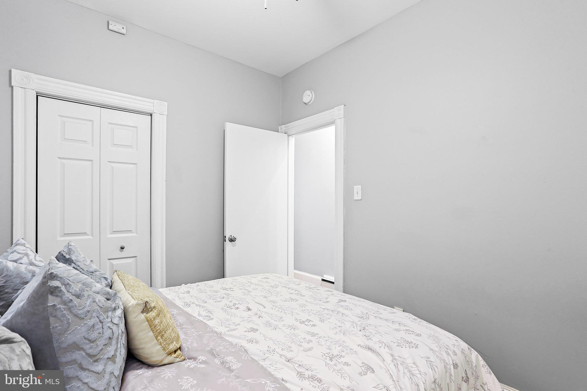 1211 33rd Street Northwest, Unit 1 Washington, DC 20007 - Photo 10 of 18 a bedroom with a bed and a window