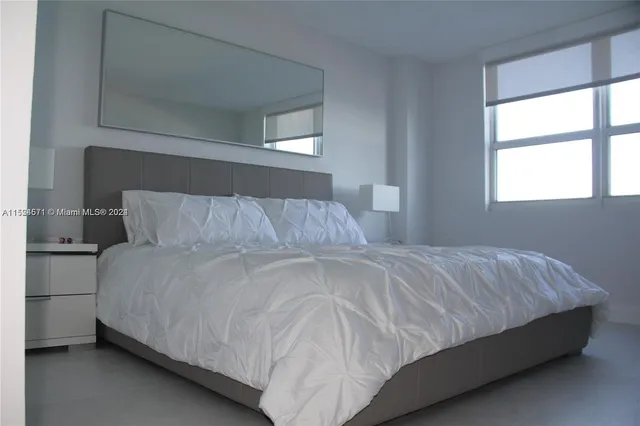 a bedroom with two beds and a window