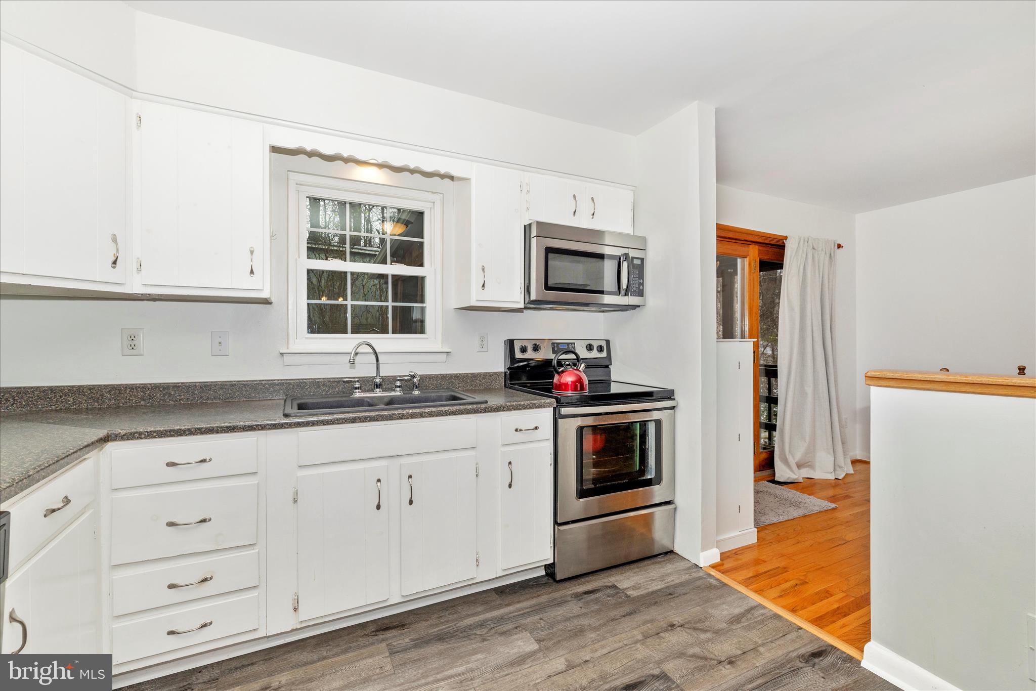 2235 Bowersox Road New Windsor, MD 21776 - Photo 12 of 35 a kitchen with granite countertop white cabinets and stainless steel appliances