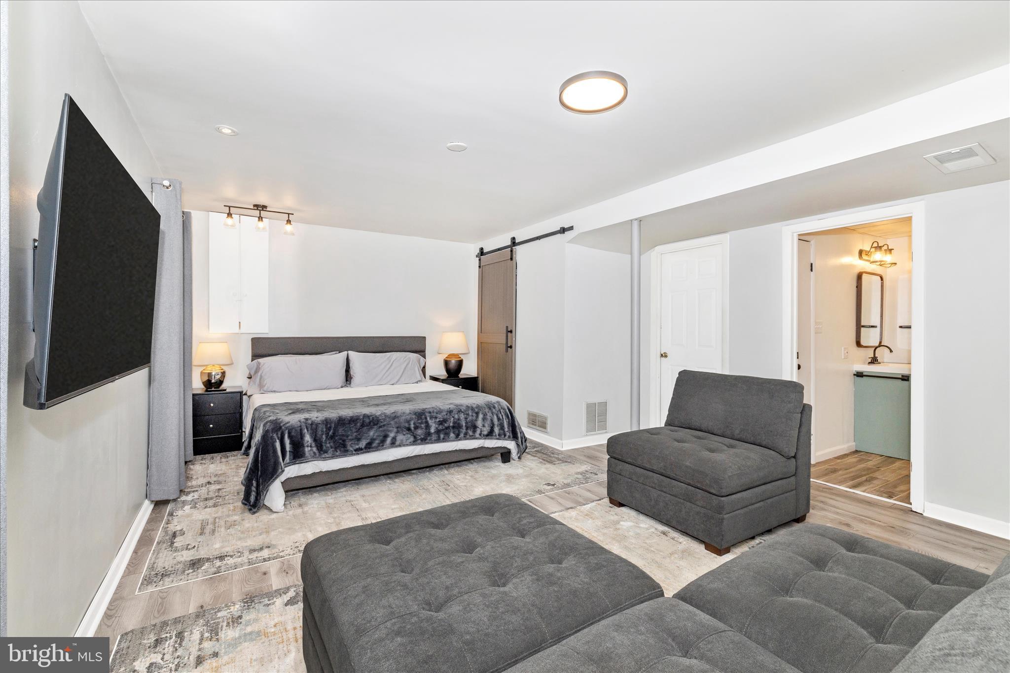 2235 Bowersox Road New Windsor, MD 21776 - Photo 26 of 35 a spacious bedroom with a bed and a flat screen tv