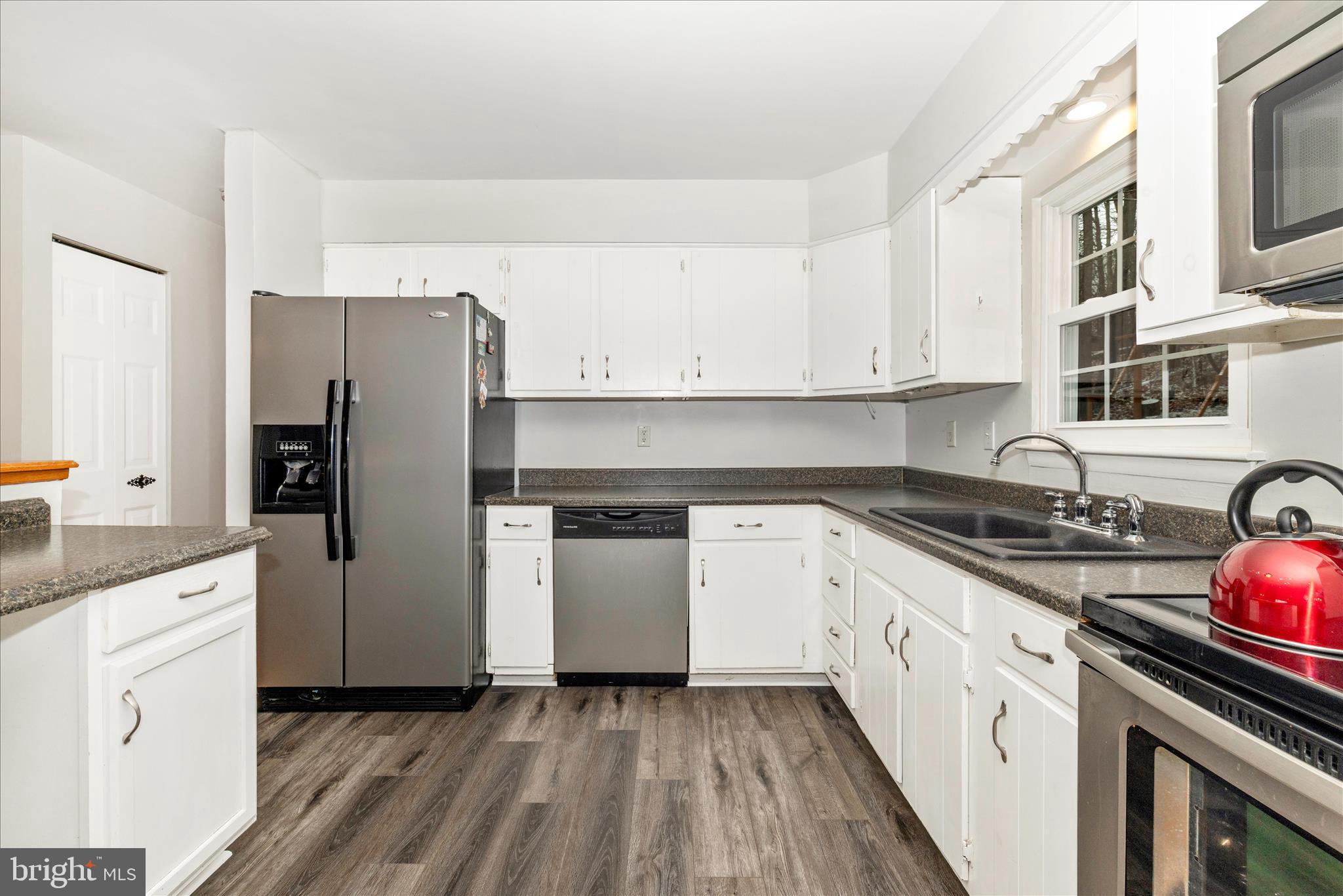 2235 Bowersox Road New Windsor, MD 21776 - Photo 9 of 35 a kitchen with stainless steel appliances granite countertop a refrigerator stove and sink
