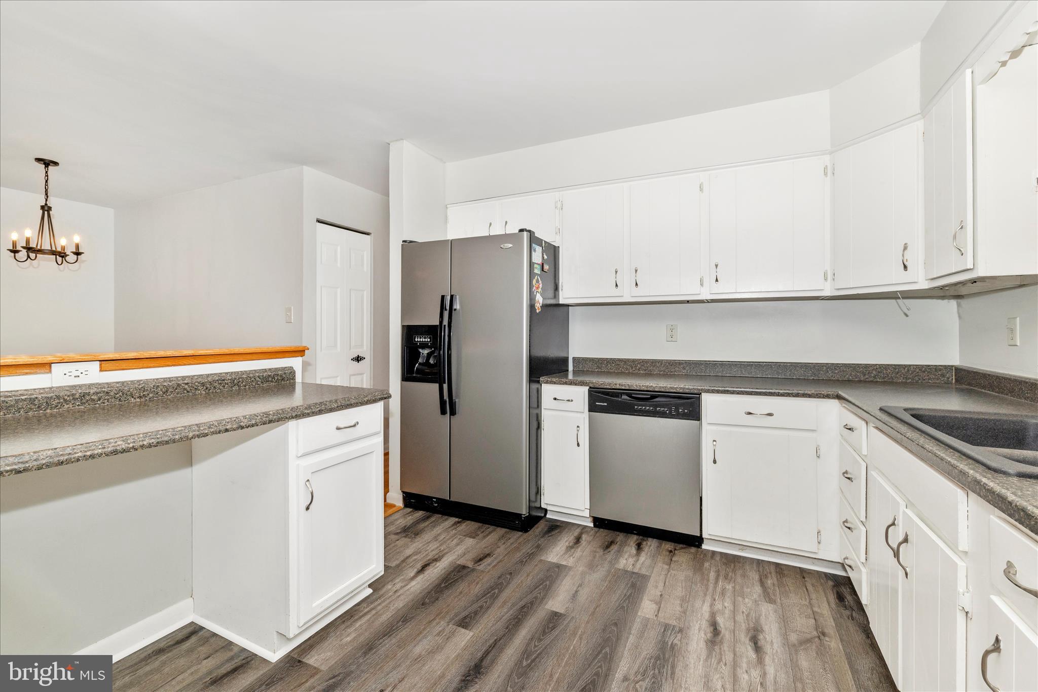 2235 Bowersox Road New Windsor, MD 21776 - Photo 10 of 35 a kitchen with stainless steel appliances granite countertop a refrigerator and a stove top oven