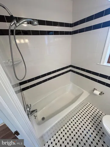 a bathroom with a shower and a glass door