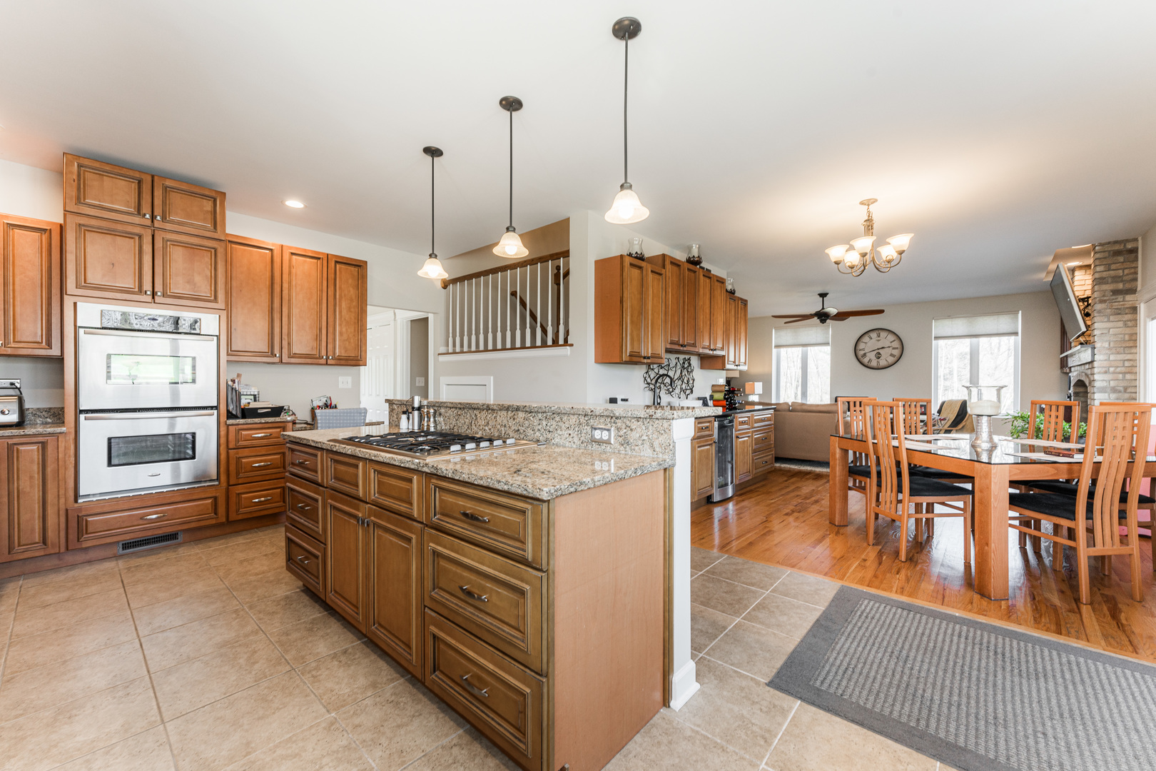 181 North Prince Crossing Road West Chicago, IL 60185 - Photo 15 of 62 a large kitchen with kitchen island a stove a sink a center island a dining table and chairs