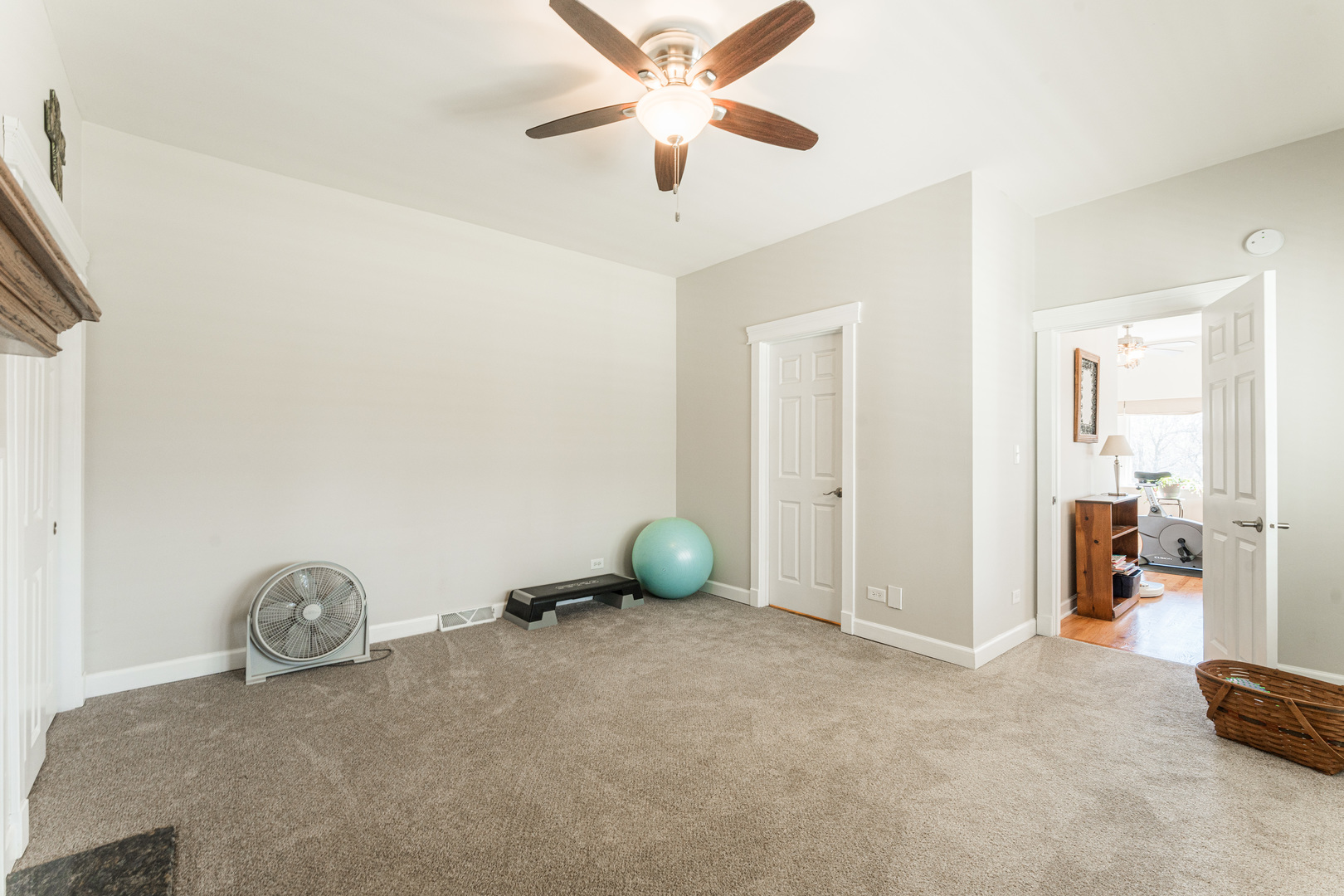181 North Prince Crossing Road West Chicago, IL 60185 - Photo 21 of 62 a view of a livingroom with wooden floor and a ceiling fan