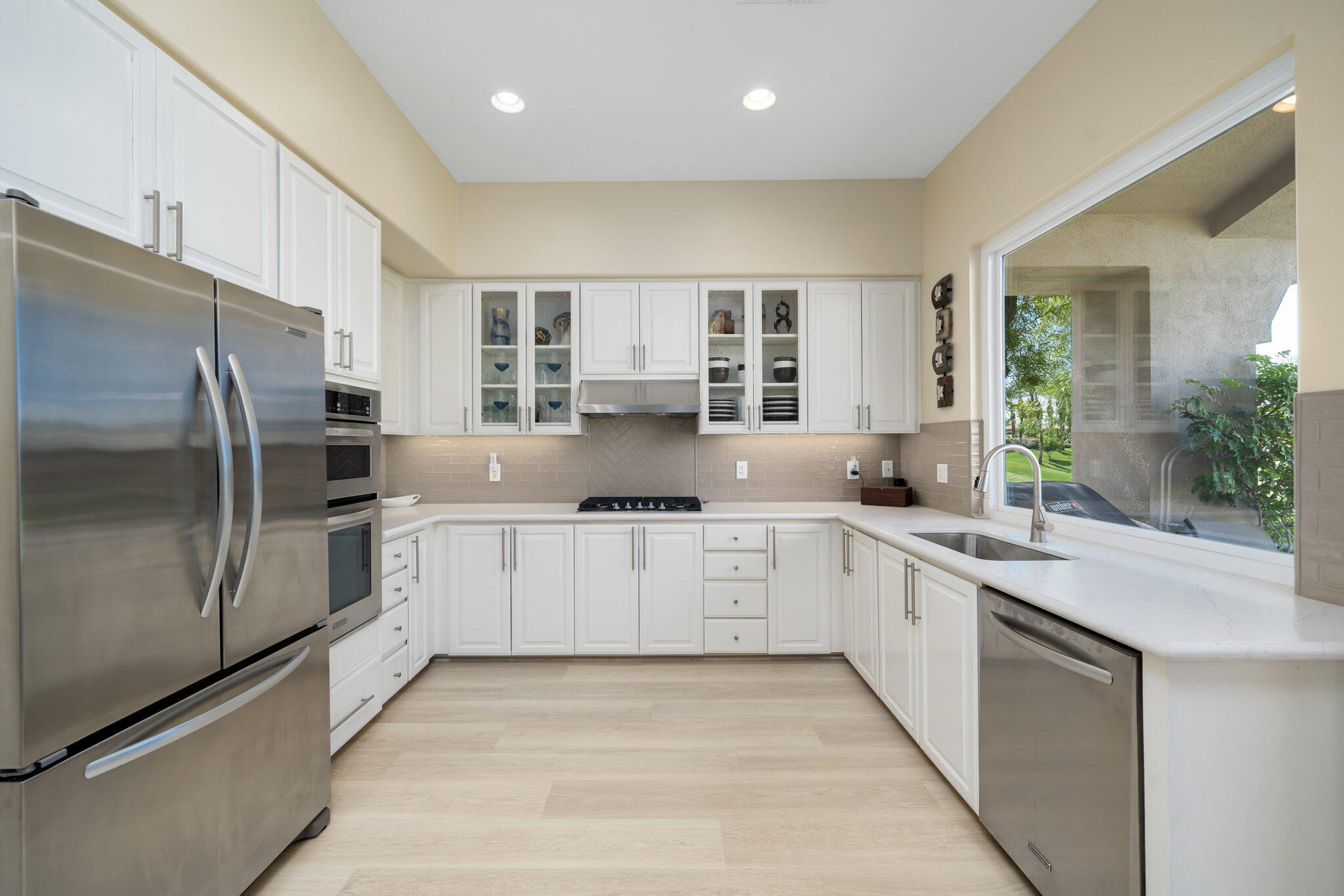 a kitchen with stainless steel appliances granite countertop a refrigerator sink and cabinets