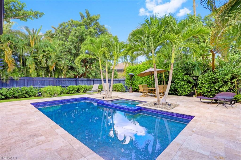 a view of backyard with swimming pool and outdoor seating