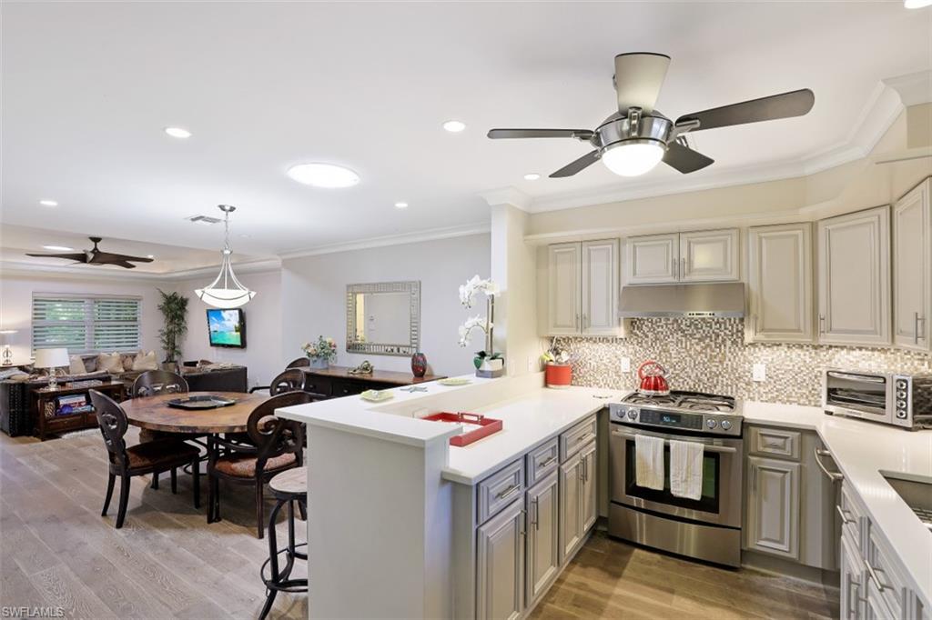 1199 9th Avenue North Naples, FL 34102 - Photo 24 of 24 a kitchen that has a lot of cabinets a sink and wooden floor