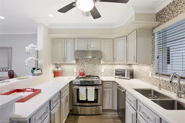 a kitchen that has a lot of cabinets a sink and wooden floor