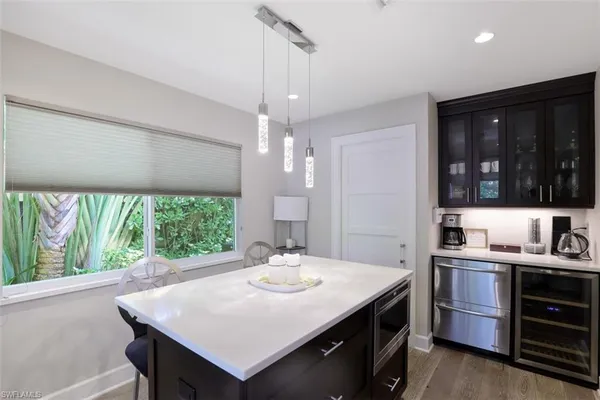 a kitchen with stainless steel appliances a sink stove and cabinets