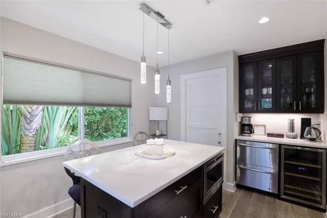 a kitchen with stainless steel appliances a sink stove and cabinets