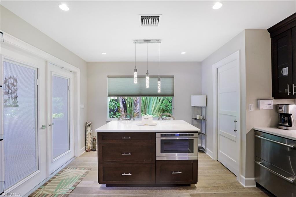 1199 9th Avenue North Naples, FL 34102 - Photo 13 of 24 a room with a stove and cabinets