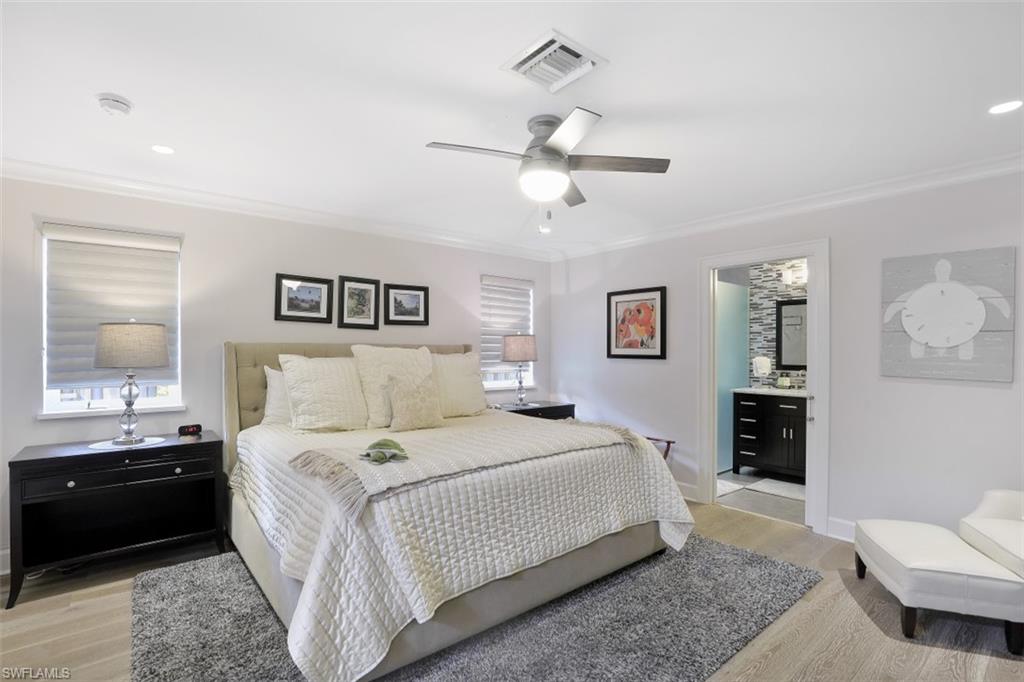 1199 9th Avenue North Naples, FL 34102 - Photo 15 of 24 a bedroom with a bed and a lamp