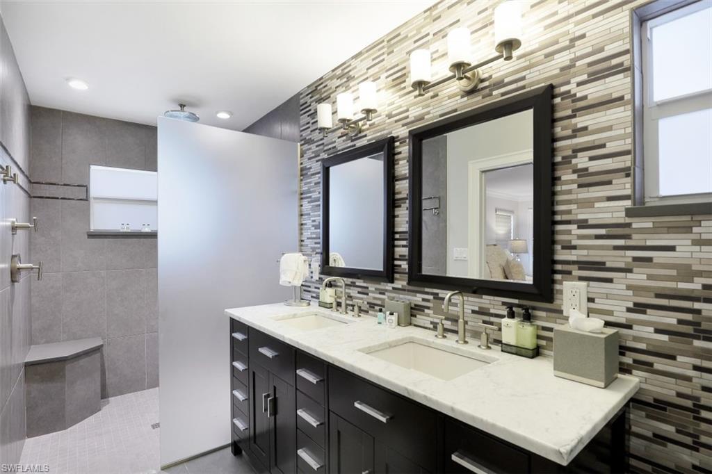 1199 9th Avenue North Naples, FL 34102 - Photo 16 of 24 a bathroom with a sink vanity granite and a mirror