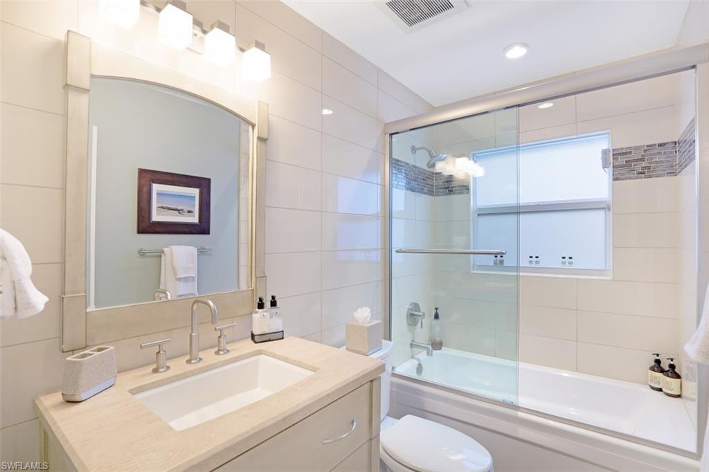 1199 9th Avenue North Naples, FL 34102 - Photo 18 of 24 a bathroom with a sink toilet tub and shower