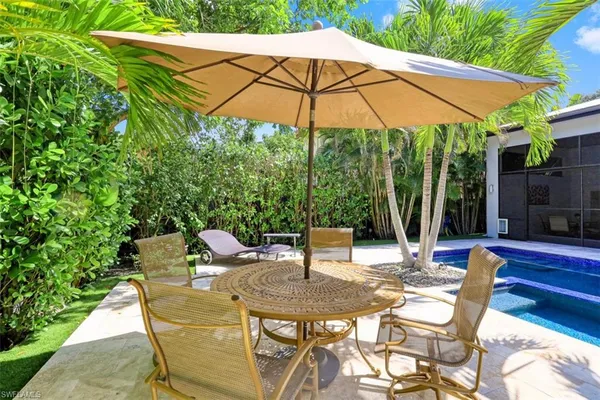 a patio with a patio table and chairs