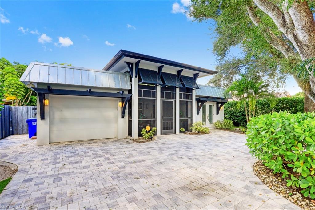 1199 9th Avenue North Naples, FL 34102 - Photo 23 of 24 a view of a house with a garage and a yard