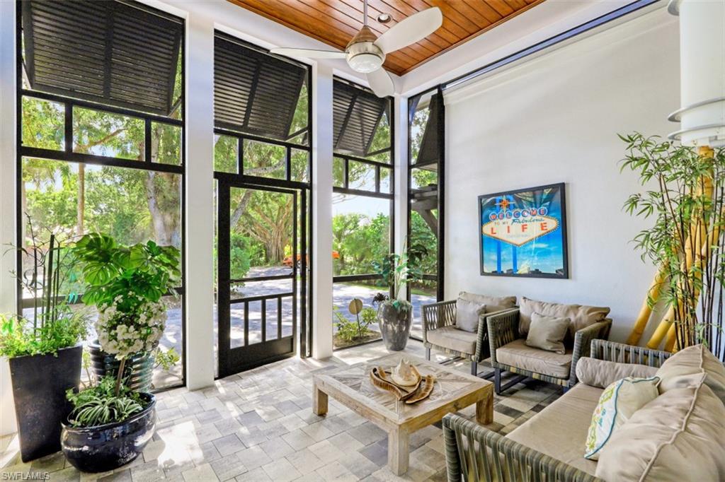 1199 9th Avenue North Naples, FL 34102 - Photo 4 of 24 a living room with patio furniture and a potted plant