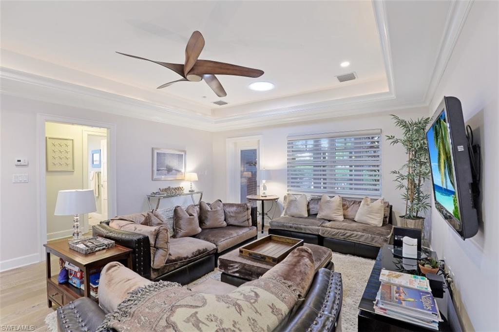 1199 9th Avenue North Naples, FL 34102 - Photo 6 of 24 a living room with furniture a flat screen tv and a window