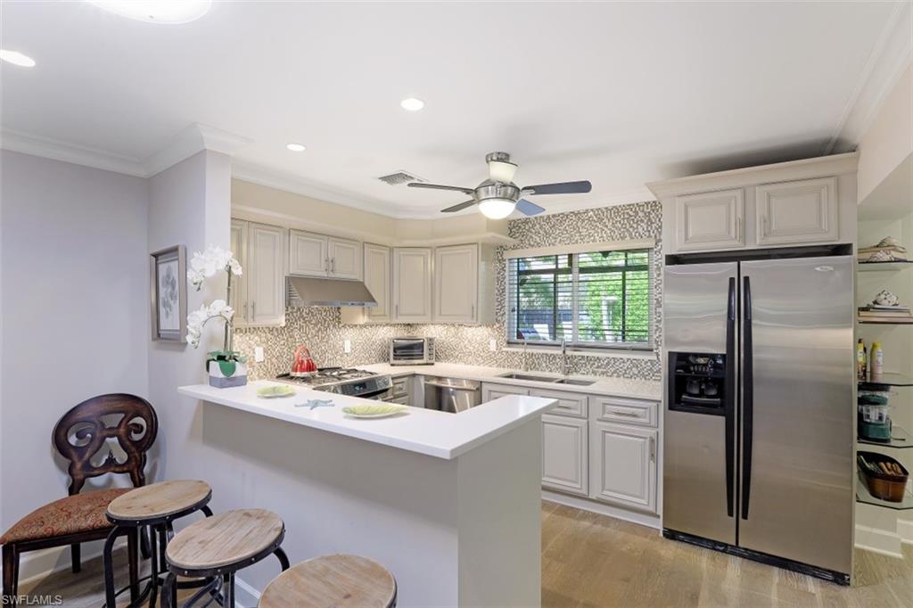 1199 9th Avenue North Naples, FL 34102 - Photo 10 of 24 a kitchen with a sink appliances and cabinets