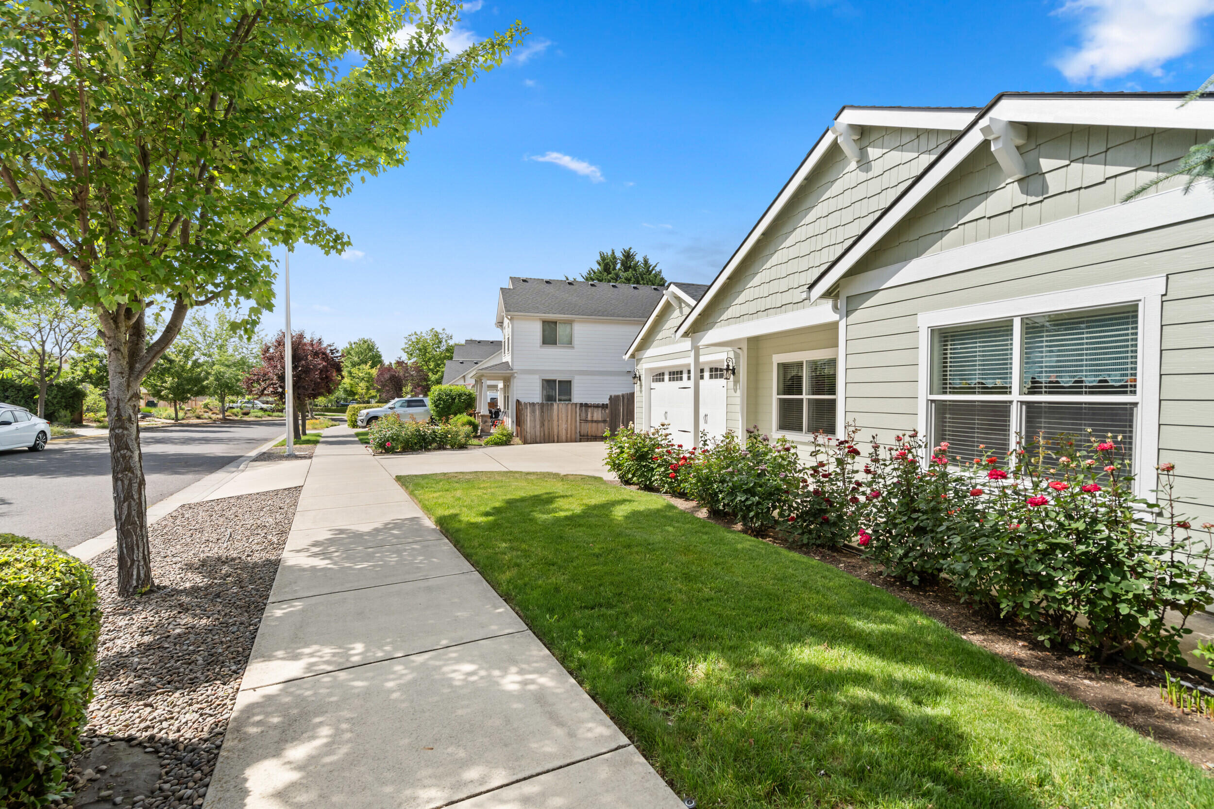 1227 Lithia Way Talent, OR 97540 - Photo 2 of 37 a front view of a house with a garden and fountain