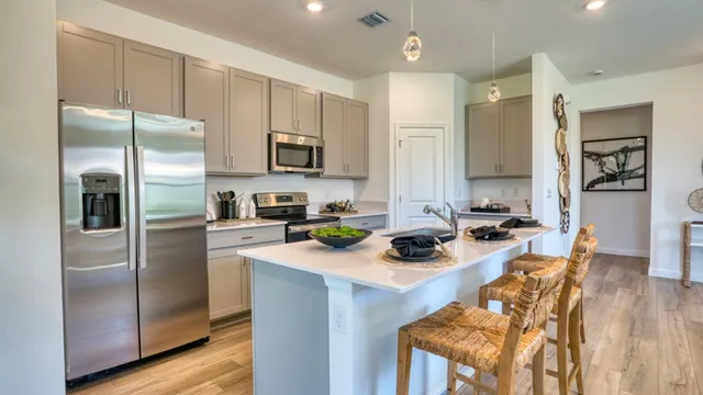 a kitchen with stainless steel appliances a refrigerator sink and cabinets