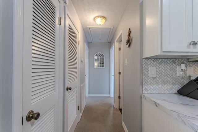 a spacious bedroom with a large bed and a flat screen tv