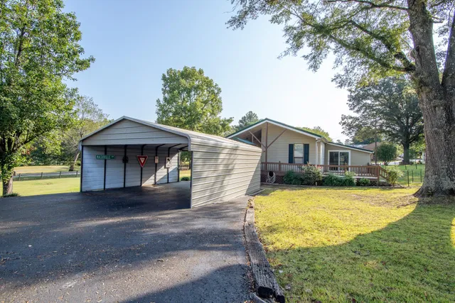 a view of a backyard with large trees