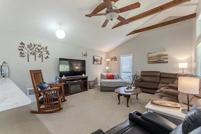 a kitchen with a sink dishwasher stove and refrigerator with wooden floor