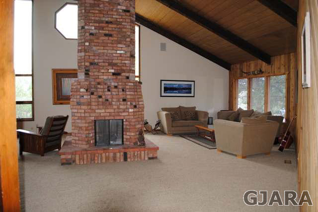 2561 I Road Grand Junction, CO 81505 - Photo 13 of 38 a living room with furniture and a fireplace