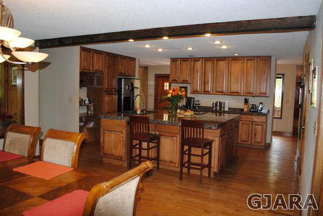 2561 I Road Grand Junction, CO 81505 - Photo 17 of 38 a living room with couches and kitchen view with wooden floor