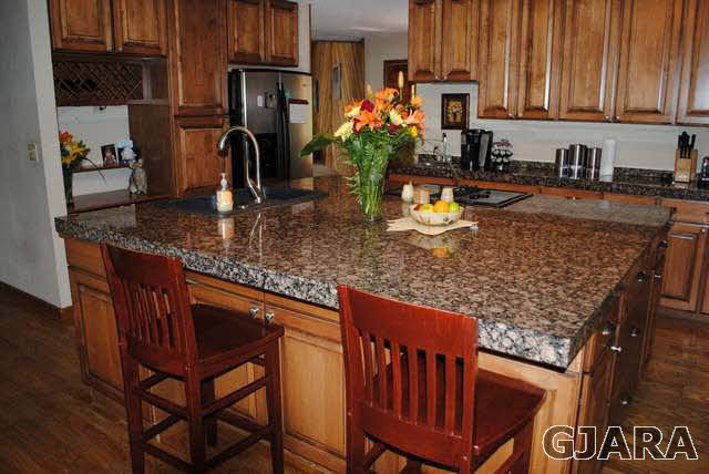 2561 I Road Grand Junction, CO 81505 - Photo 18 of 38 a kitchen with granite countertop a sink chairs and cabinets