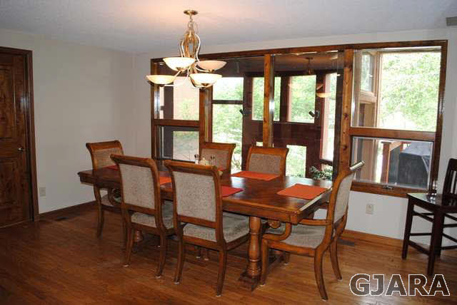 2561 I Road Grand Junction, CO 81505 - Photo 20 of 38 a dining room with furniture large windows and a chandelier