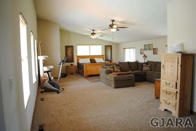 2561 I Road Grand Junction, CO 81505 - Photo 21 of 38 a living room with furniture and a chandelier