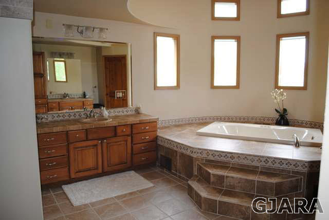 2561 I Road Grand Junction, CO 81505 - Photo 22 of 38 a bathroom with a sink and a mirror