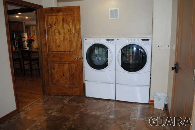 2561 I Road Grand Junction, CO 81505 - Photo 31 of 38 a utility room with dryer washer and a view of living room