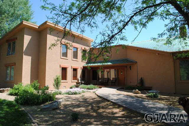 2561 I Road Grand Junction, CO 81505 - Photo 34 of 38 a front view of a house with a yard