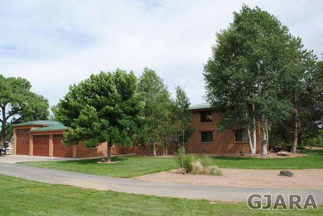 2561 I Road Grand Junction, CO 81505 - Photo 4 of 38 a front view of a house with garden