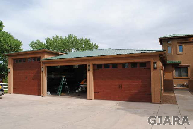 2561 I Road Grand Junction, CO 81505 - Photo 10 of 38 a front view of a house with a yard and garage