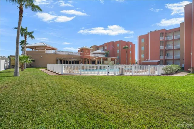 a view of a building with garden and bench