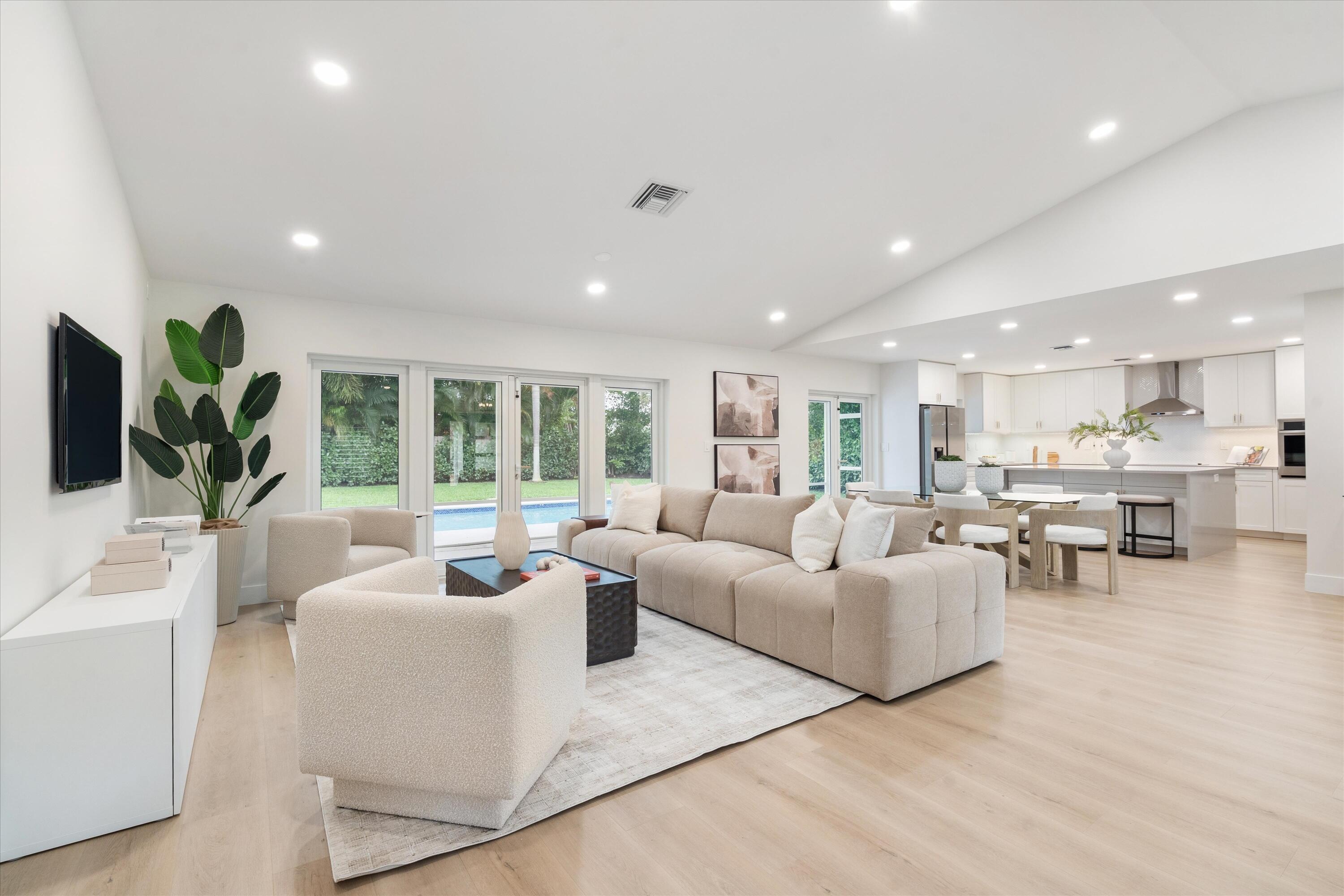 1480 Southwest 19th Street Boca Raton, FL 33486 - Photo 57 of 62 a living room with furniture and a flat screen tv