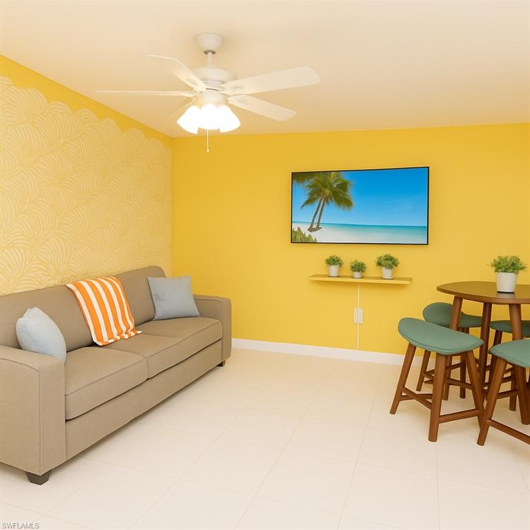 726 Park Avenue Naples, FL 34110 - Photo 15 of 32 a living room with a couch and a dining table with a large window