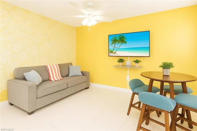 a living room with a couch and a dining table