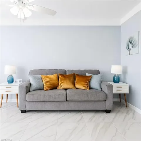 a living room with a couches and painting on the wall