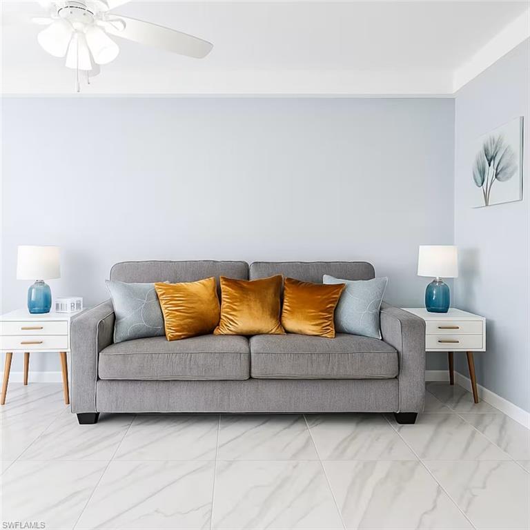 726 Park Avenue Naples, FL 34110 - Photo 2 of 32 a living room with a couches and painting on the wall
