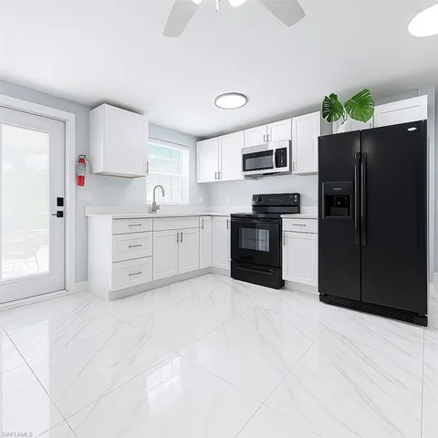 a large kitchen with cabinets and stainless steel appliances
